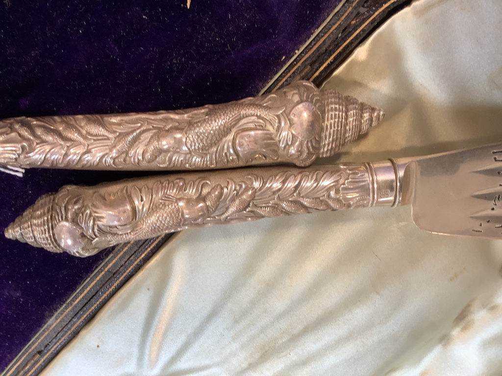 A cased ornate pair of Victorian silver fish servers, Aldwinckle & Slater